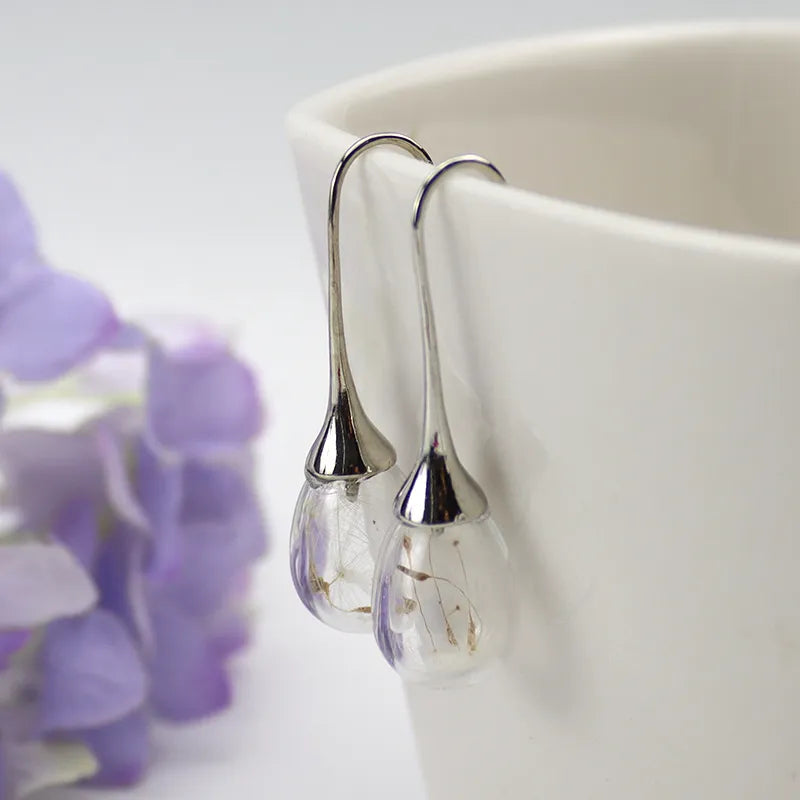 2 pares aretes con forma de globo y semilla de diente de león