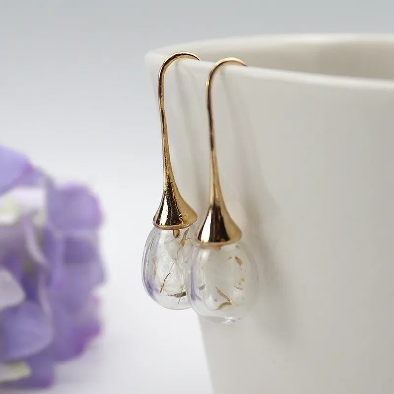 2 pares aretes con forma de globo y semilla de diente de león